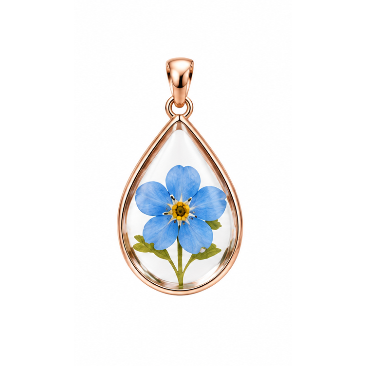 A Piece of Them blue forget-me-not teardrop memorial pendant with rose gold frame and bail; illustrative render.