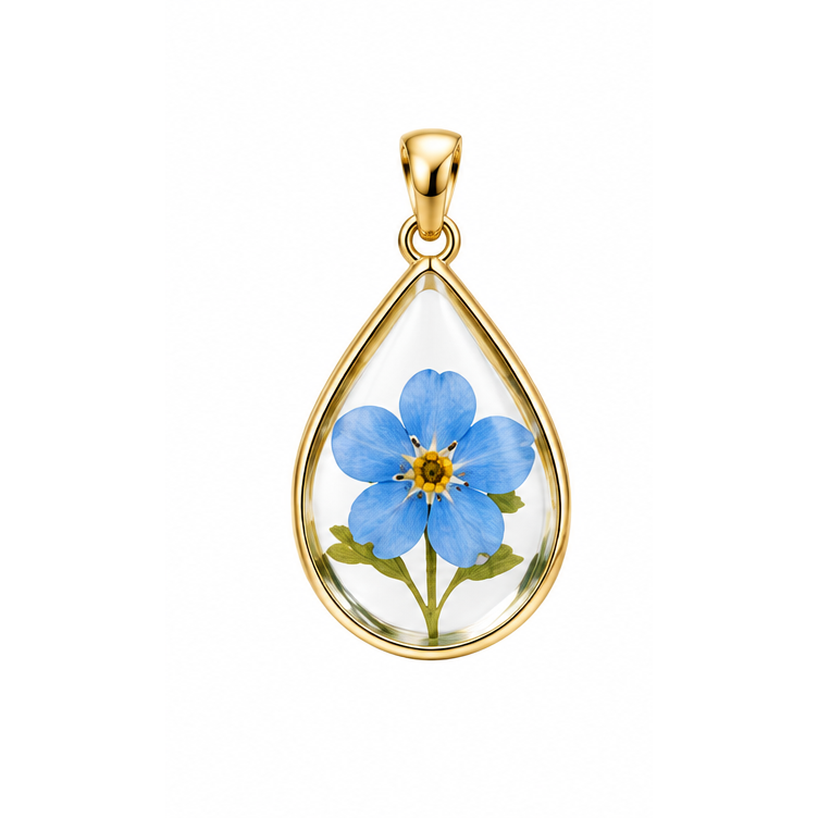 A Piece of Them blue forget-me-not teardrop memorial pendant with yellow gold frame and bail; illustrative render.