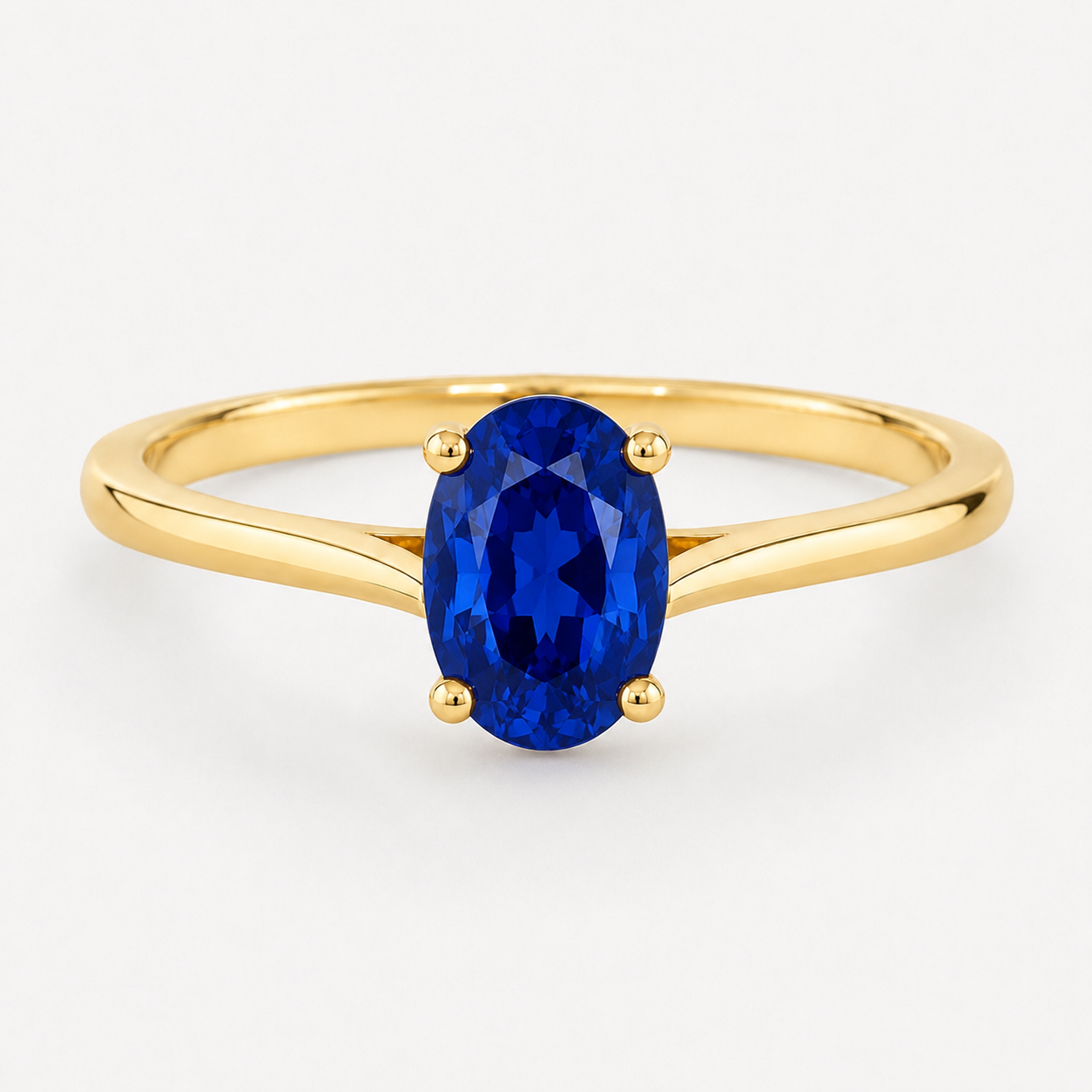 0.50 carat oval-cut laboratory-created blue sapphire solitaire ring in 14K yellow gold