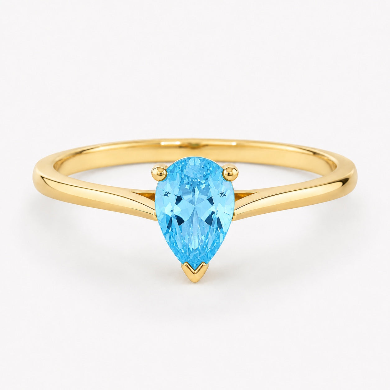 0.50 carat pear-cut blue topaz solitaire ring in 14K yellow gold