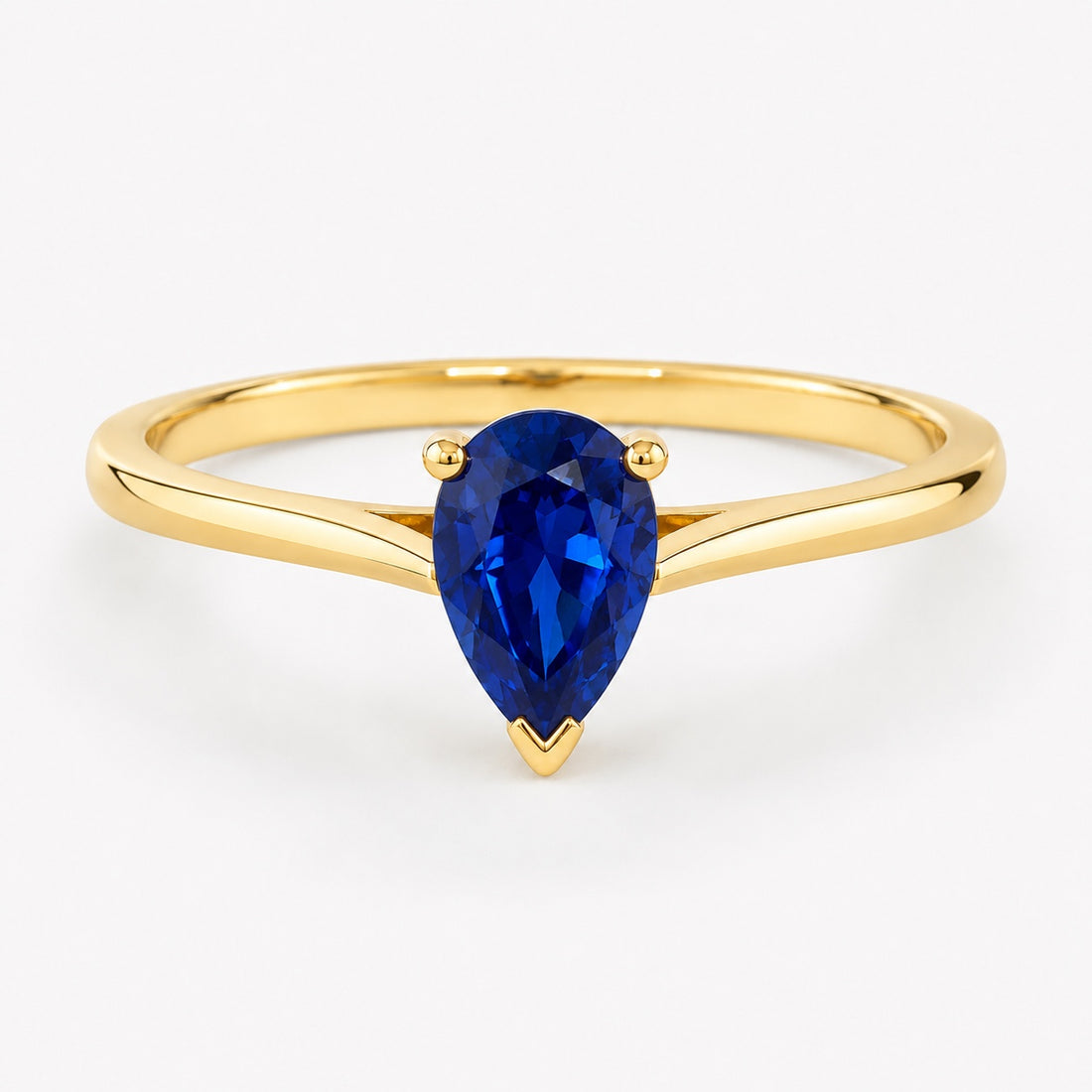 0.50 carat pear-cut laboratory-created blue sapphire solitaire ring in 14K yellow gold