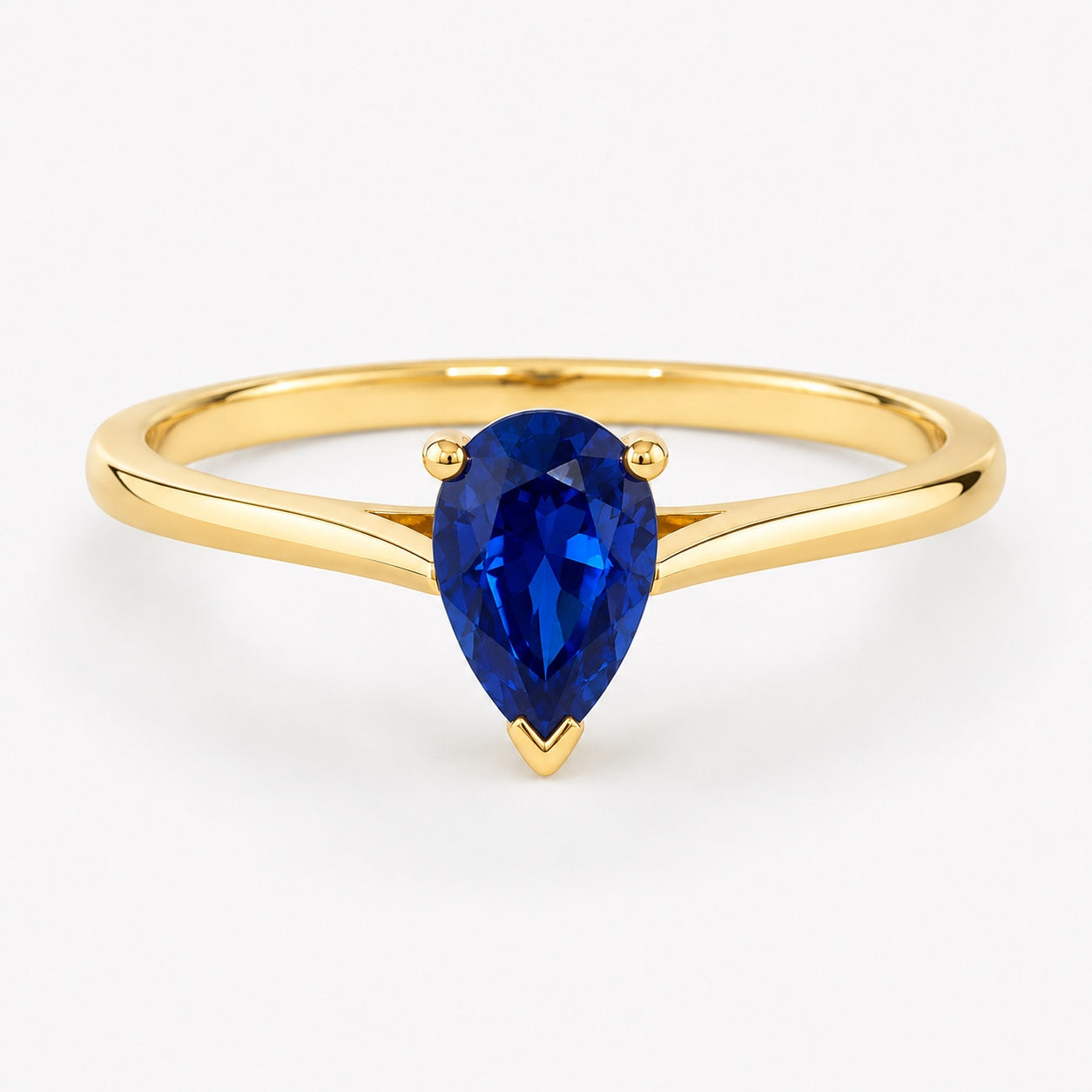 0.50 carat pear-cut laboratory-created blue sapphire solitaire ring in 14K yellow gold