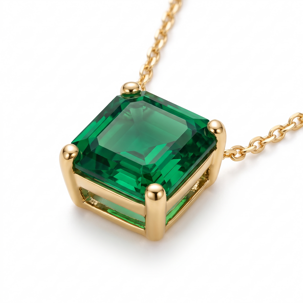 Asscher-Cut Emerald Solitaire Necklace in Solid Gold macro gemstone and setting view on white background