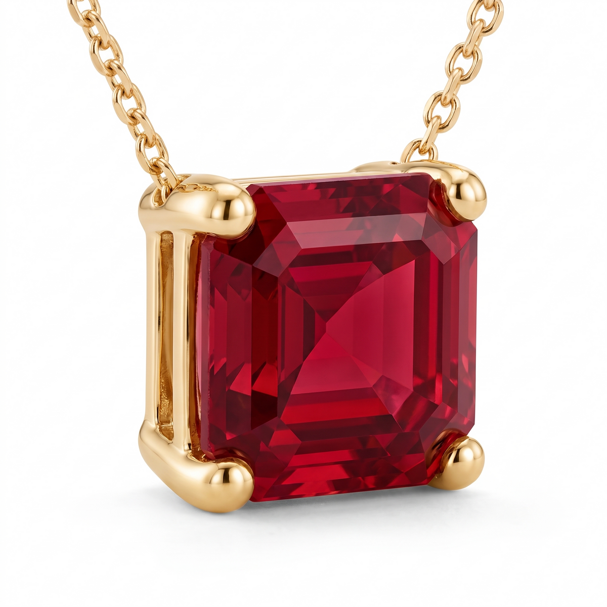 Asscher-Cut Ruby Solitaire Necklace in Solid Gold macro gemstone and setting view on white background