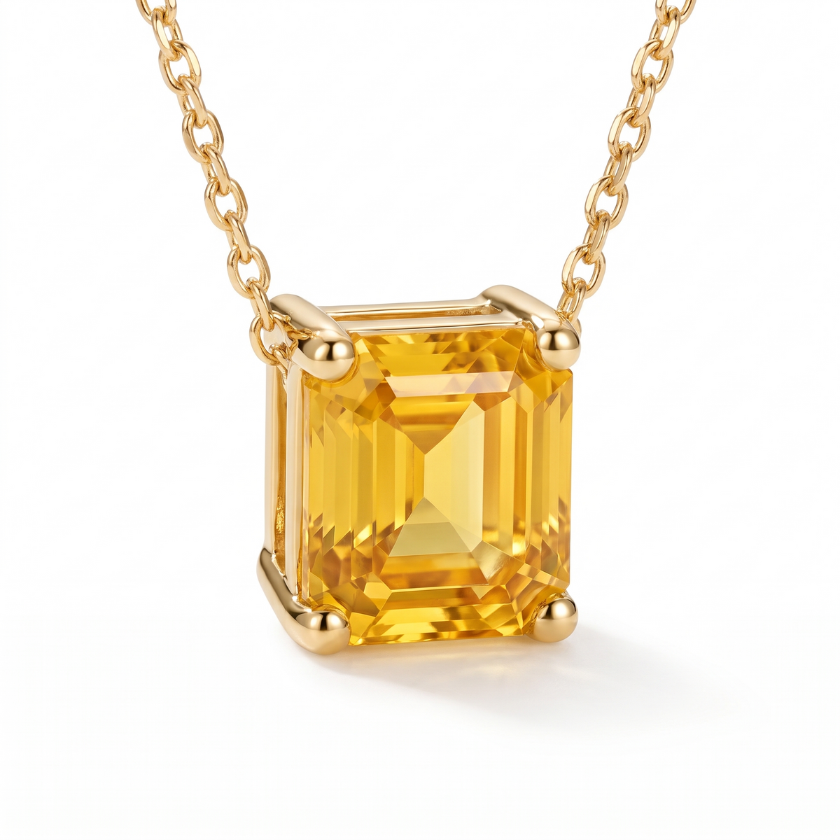 Asscher-Cut Yellow Sapphire Solitaire Necklace in Solid Gold macro gemstone and setting view on white background