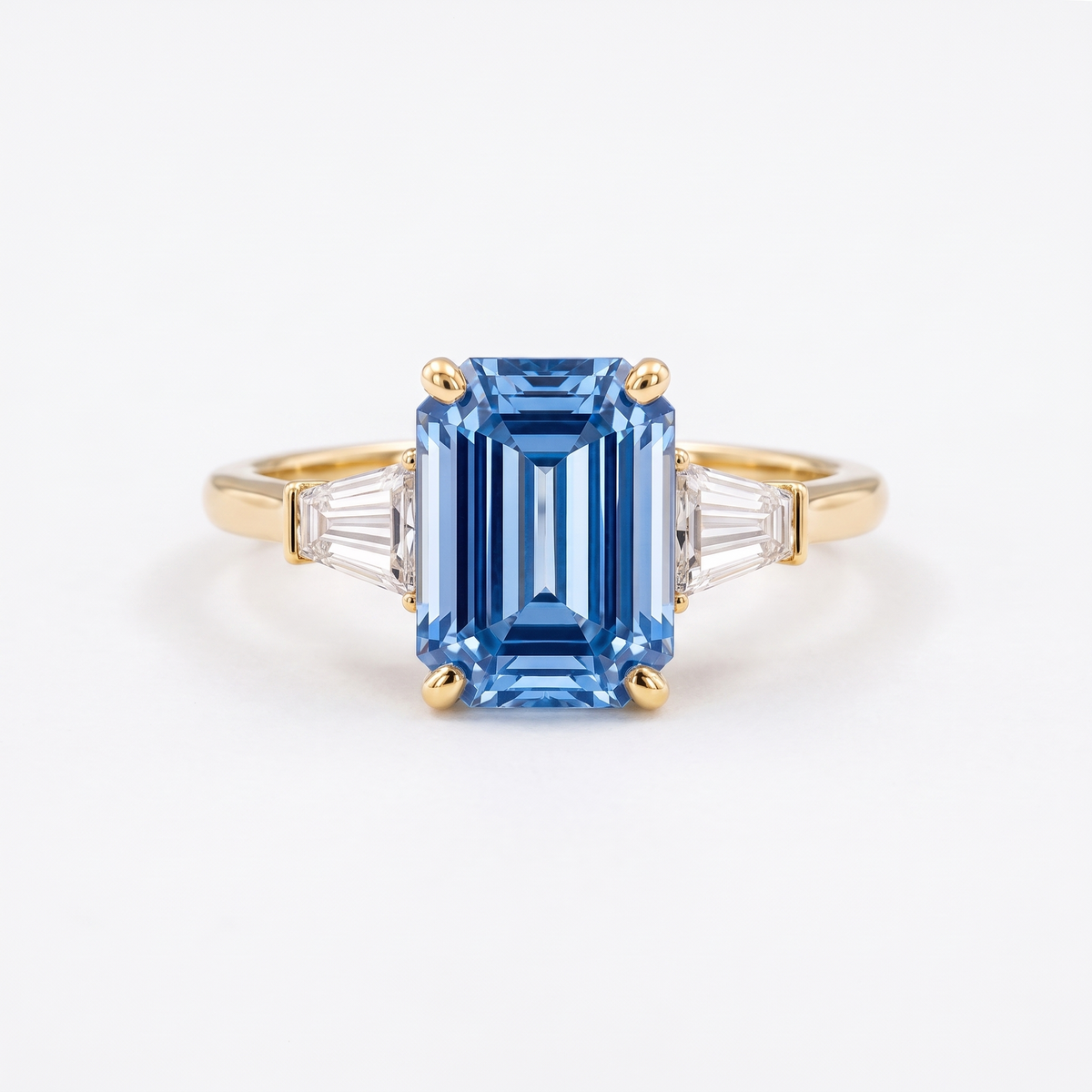 Blue emerald-cut lab-grown diamond three-stone engagement ring catalog hero on white background