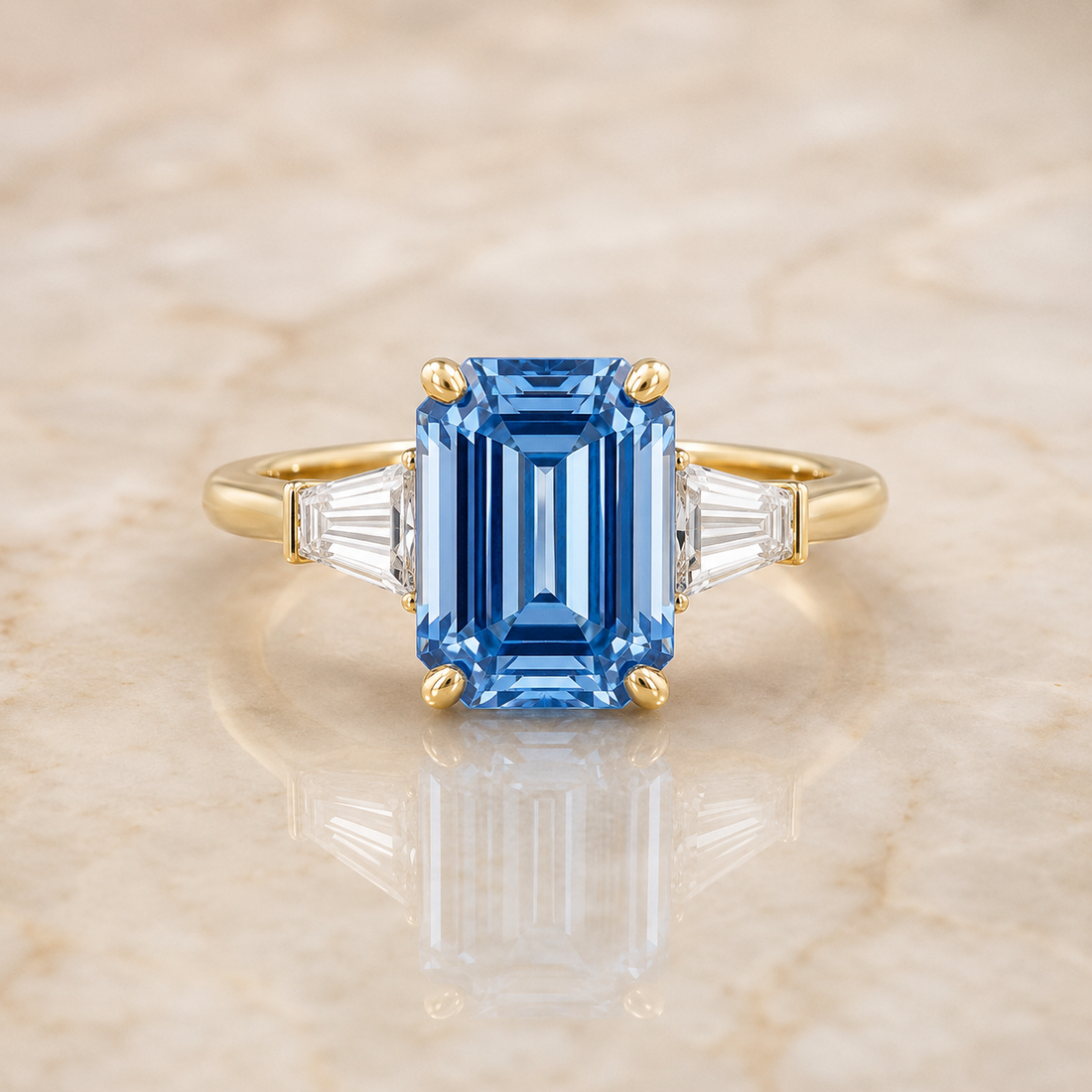 Blue emerald-cut lab-grown diamond three-stone engagement ring in 14K yellow gold