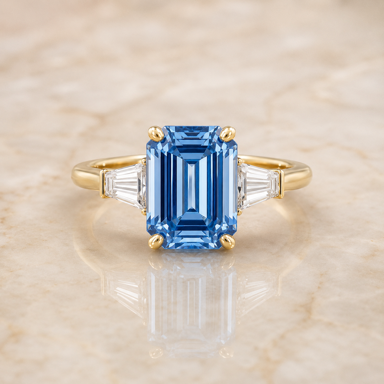 Blue emerald-cut lab-grown diamond three-stone engagement ring in 14K yellow gold