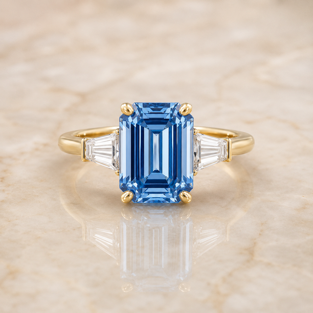 Blue emerald-cut lab-grown diamond three-stone engagement ring in 14K yellow gold
