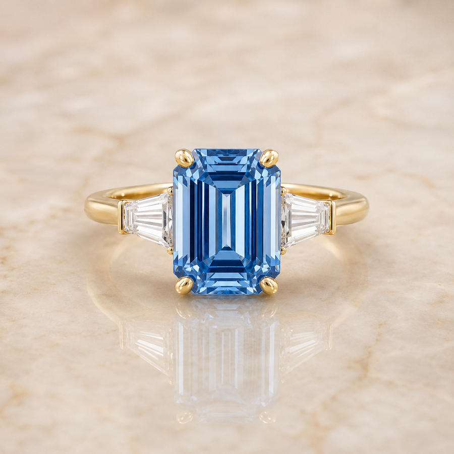 Blue emerald-cut lab-grown diamond three-stone engagement ring in 14K yellow gold