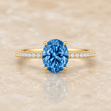 Blue oval lab-grown diamond pavé engagement ring in 14K yellow gold