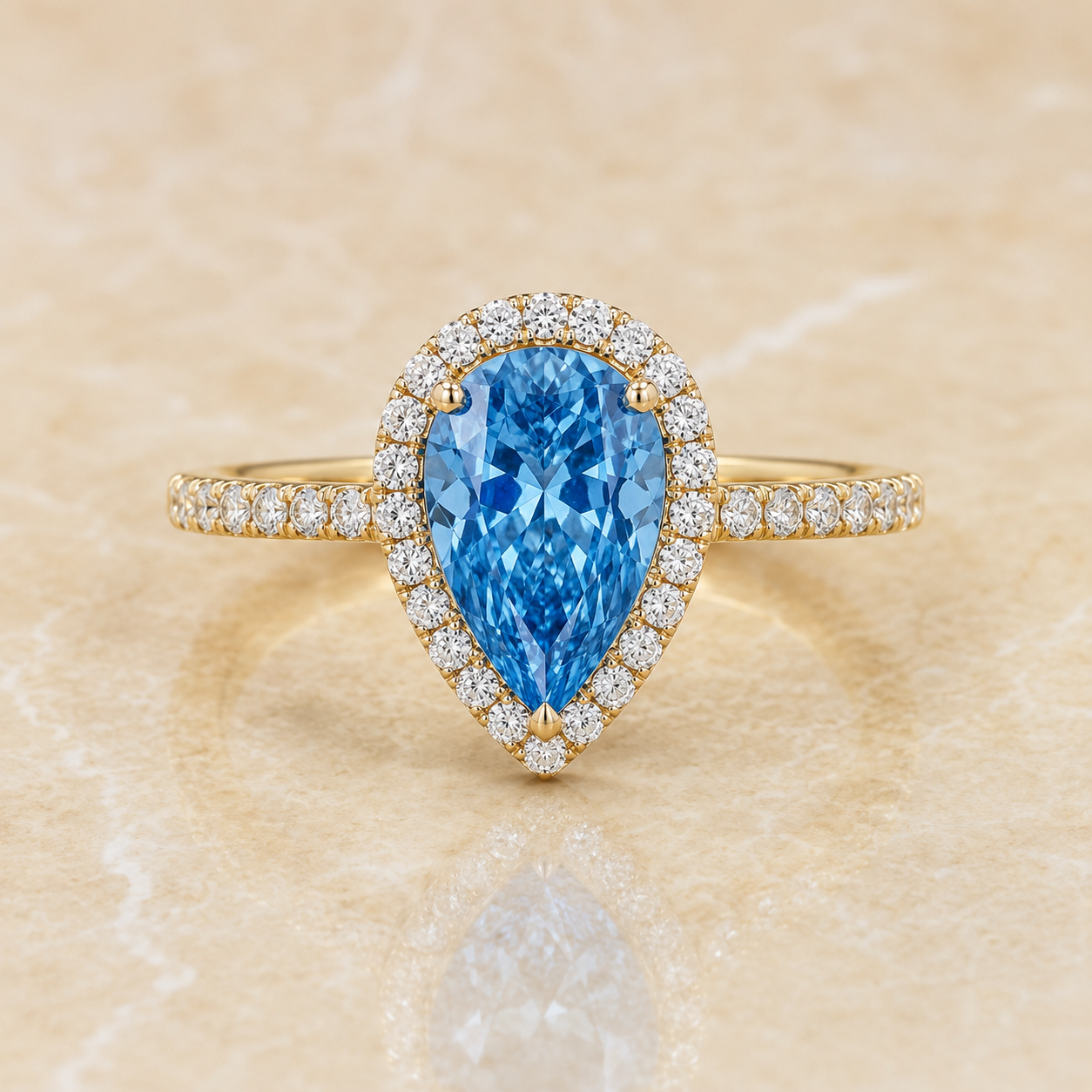 Blue pear-shaped lab-grown diamond halo engagement ring in 14K yellow gold