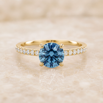 Blue round lab-grown diamond pavé engagement ring in 14K yellow gold