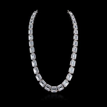 1Luxury graduated emerald-cut diamond tennis necklace design render on a black background