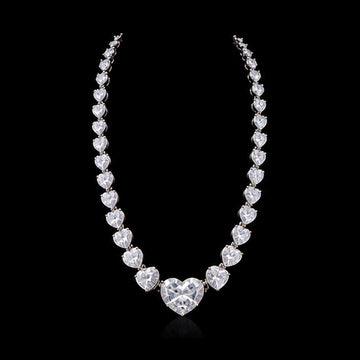 1Luxury graduated heart-cut diamond tennis necklace design render on a black background