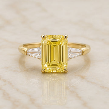 Regent emerald-cut yellow lab-grown diamond three-stone engagement ring with tapered side stones
