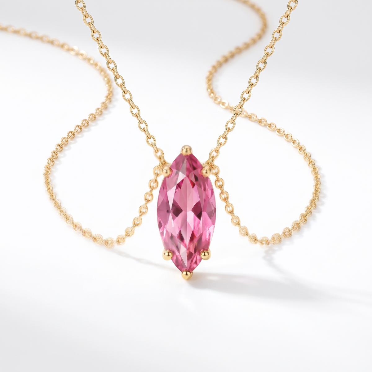 Marquise-cut pink tourmaline solitaire necklace in solid gold, catalog view — AI-generated design representation