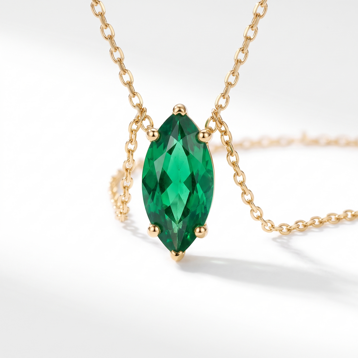 Marquise-cut emerald solitaire necklace, angled front detail — AI-generated design representation