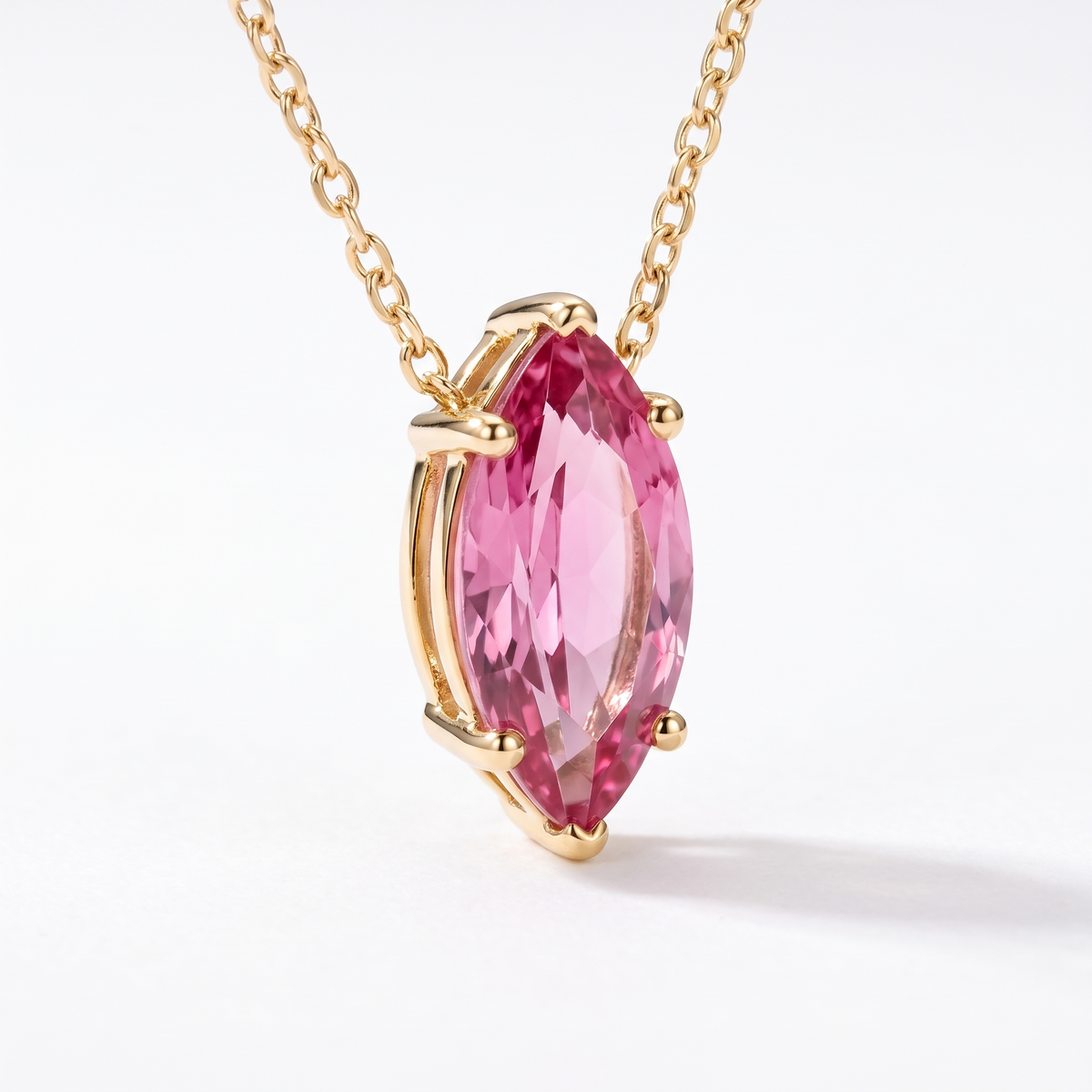 Marquise-cut pink tourmaline solitaire necklace, angled front detail — AI-generated design representation