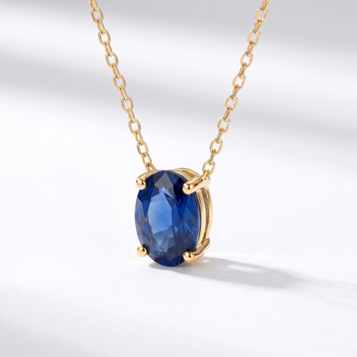 Oval-cut blue sapphire solitaire necklace, angled front detail — AI-generated design representation