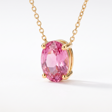 Oval-cut pink tourmaline solitaire necklace, gemstone and setting detail — AI-generated design representation