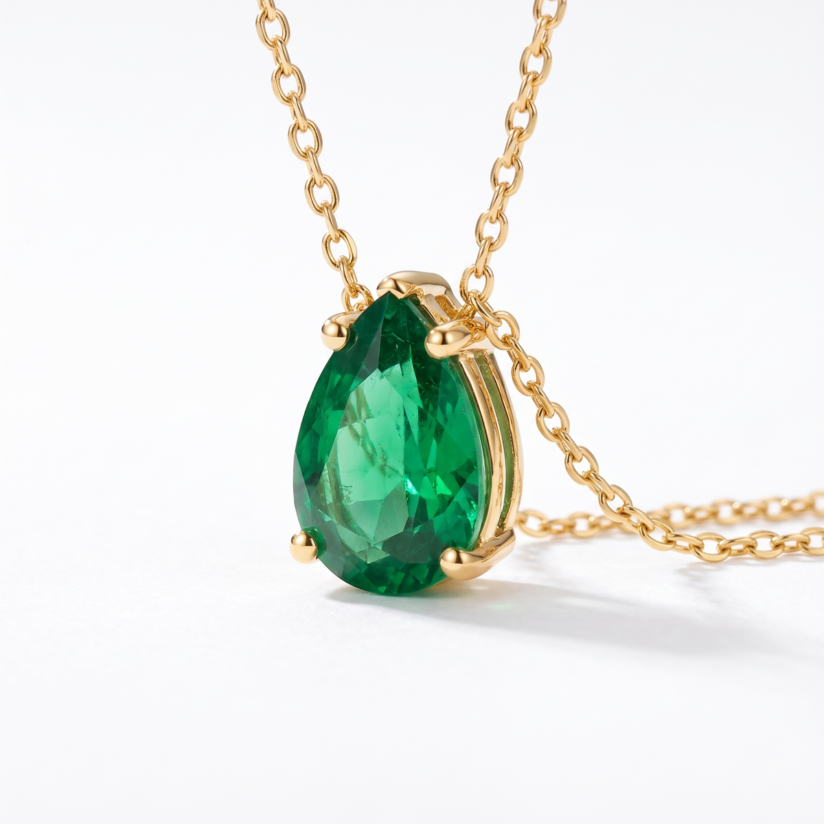 Pear-cut emerald solitaire necklace, gemstone and setting detail — AI-generated design representation