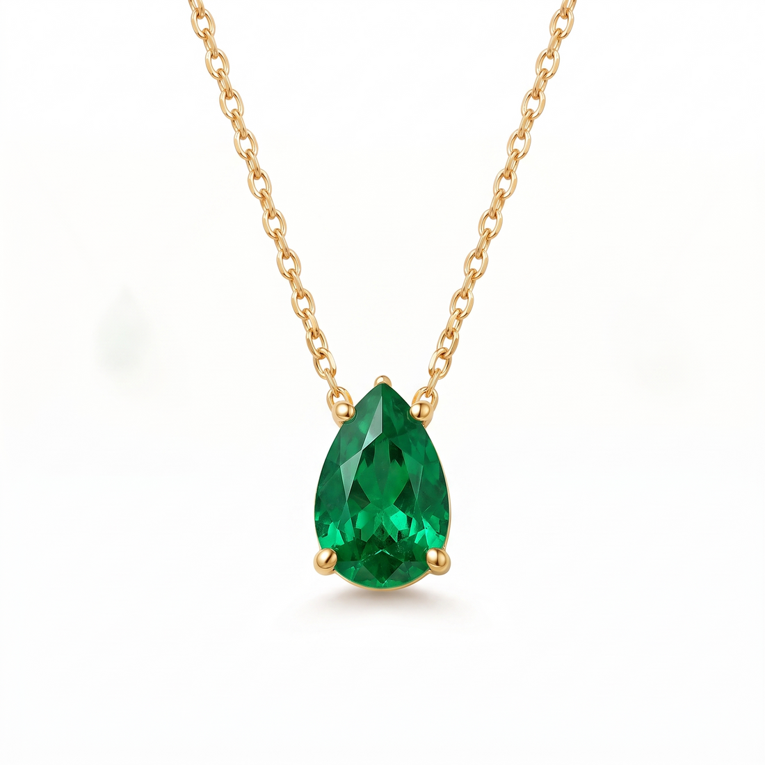 Pear-cut emerald solitaire necklace in solid gold, catalog view — AI-generated design representation