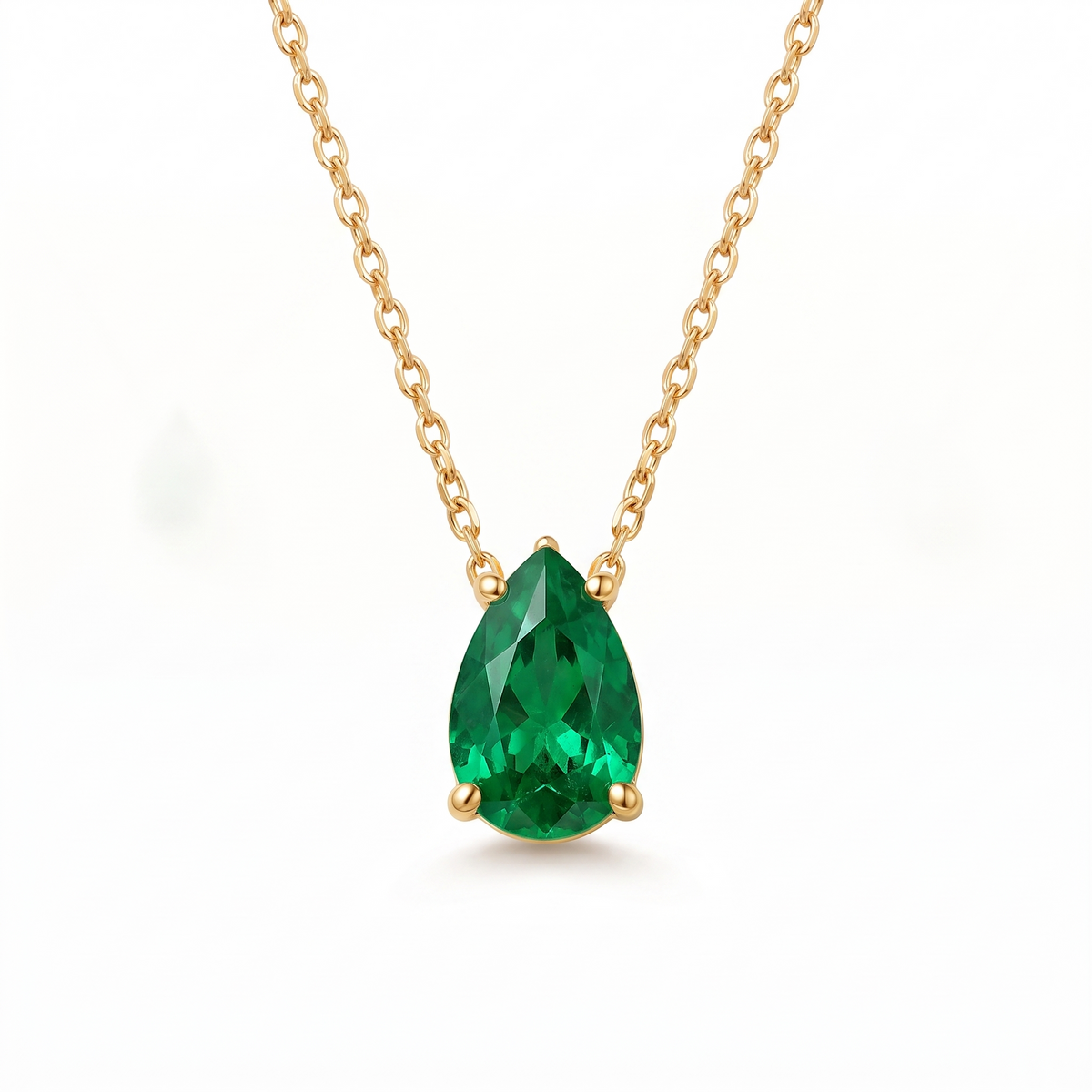 Pear-cut emerald solitaire necklace in solid gold, catalog view — AI-generated design representation