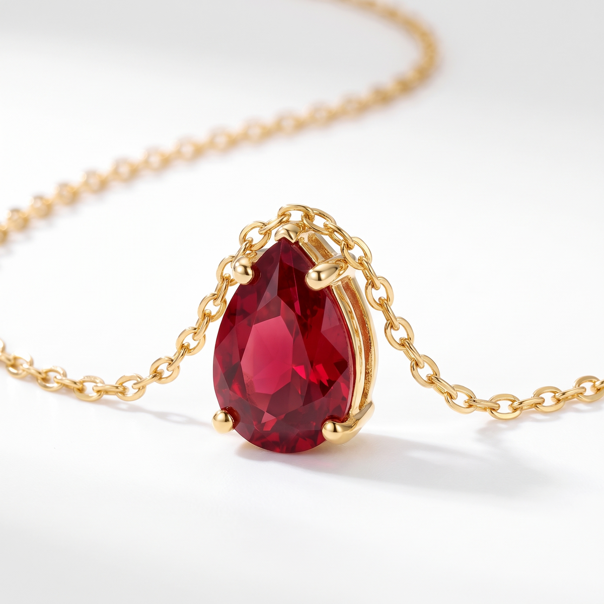 Pear-cut ruby solitaire necklace, angled front detail — AI-generated design representation