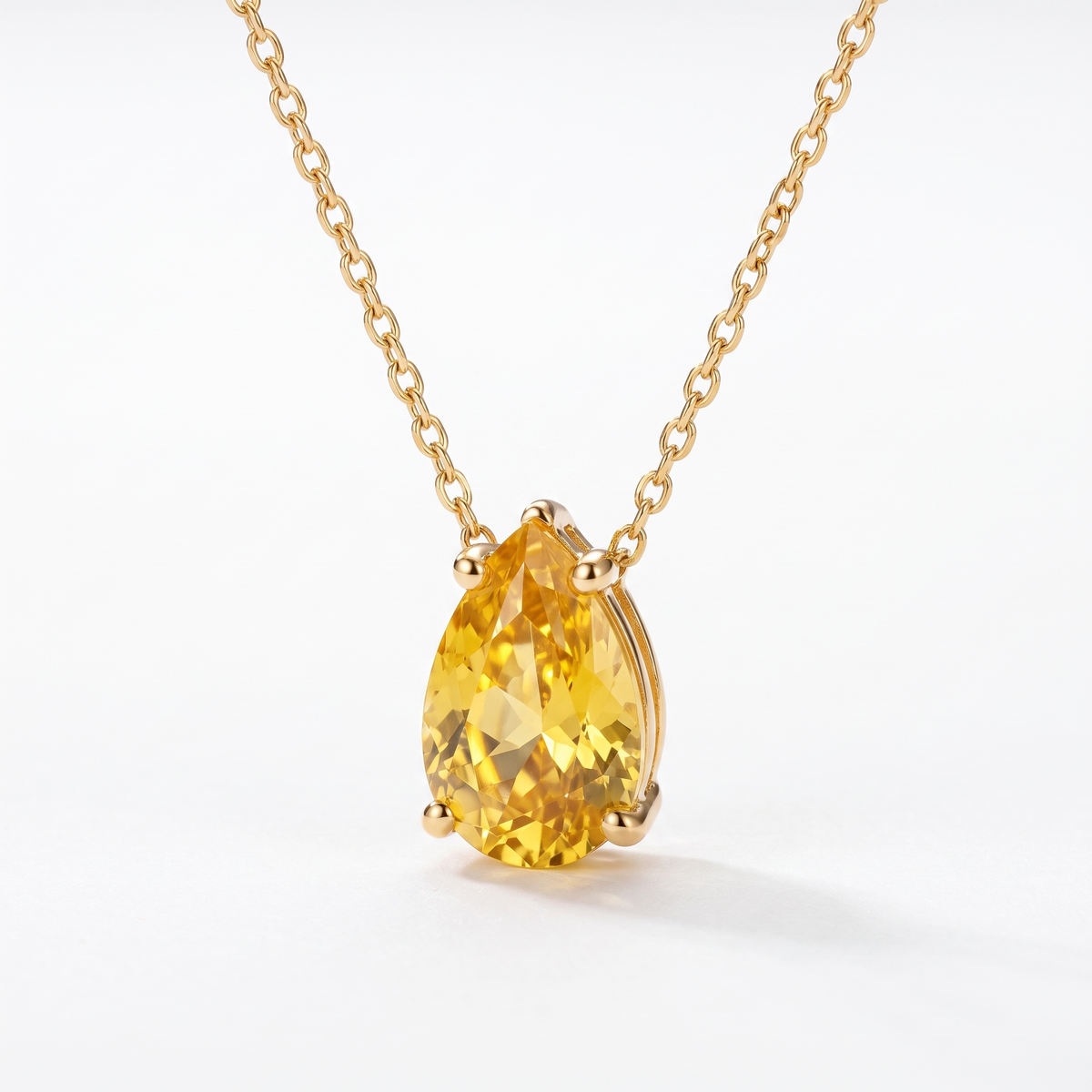 Pear-cut yellow sapphire solitaire necklace, angled front detail — AI-generated design representation