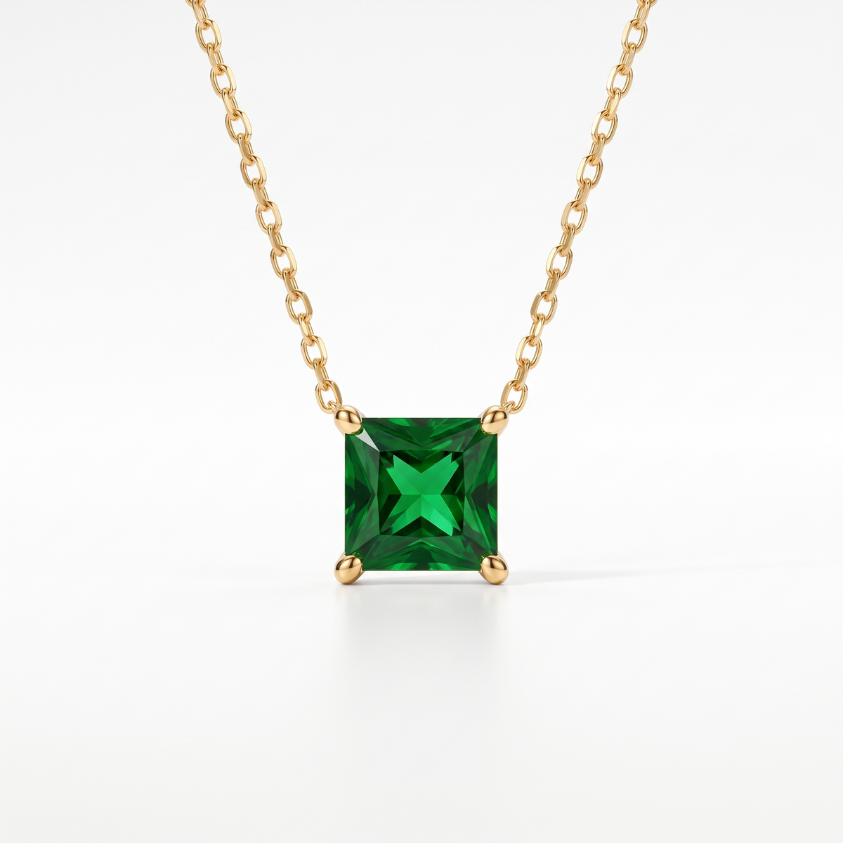 Princess-cut emerald solitaire necklace in solid gold, catalog view — AI-generated design representation
