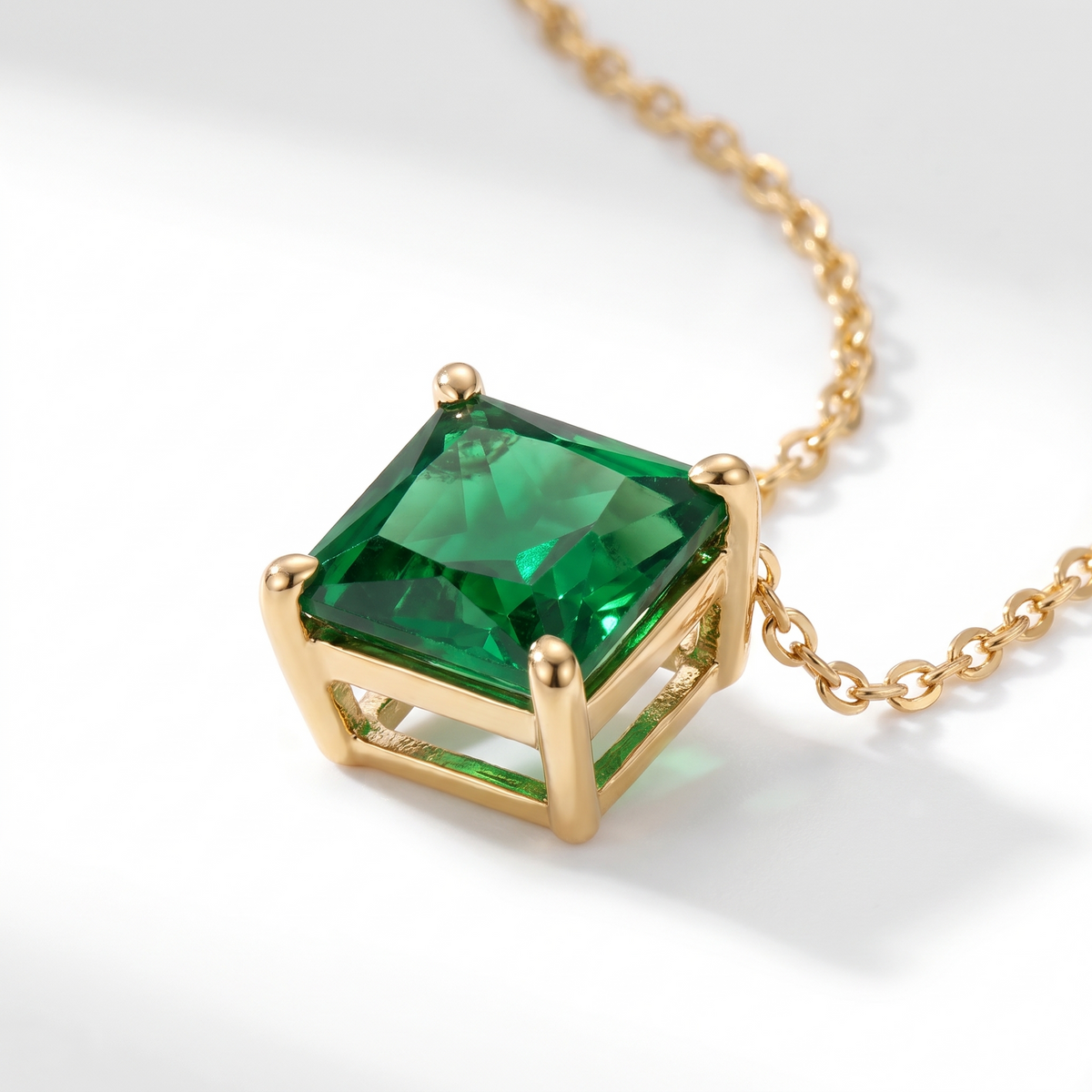 Princess-cut emerald solitaire necklace, gemstone and setting detail — AI-generated design representation
