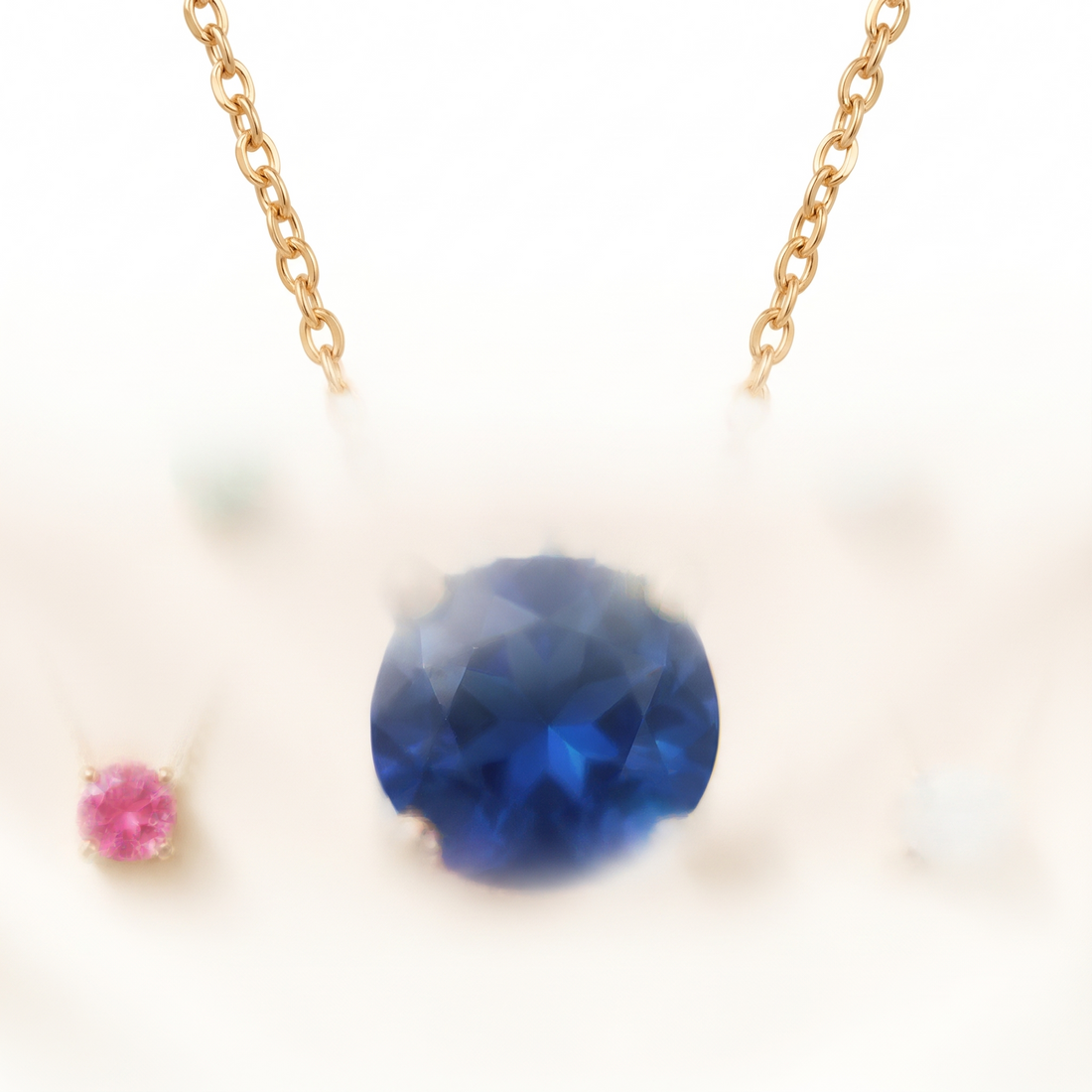 Round-cut blue sapphire solitaire necklace in solid gold, catalog view — AI-generated design representation