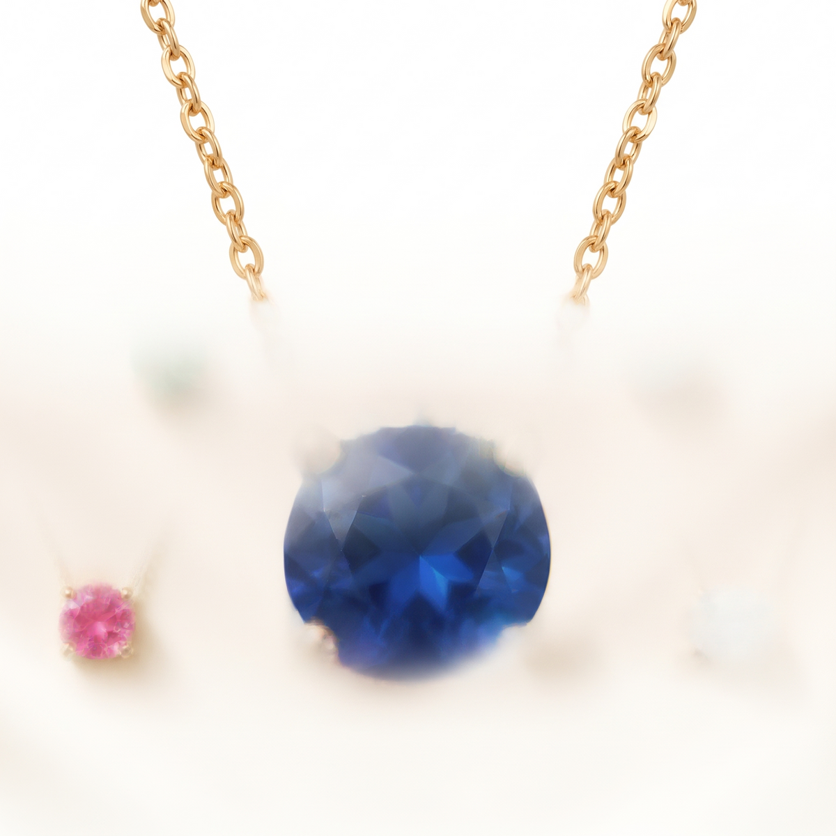 Round-cut blue sapphire solitaire necklace in solid gold, catalog view — AI-generated design representation
