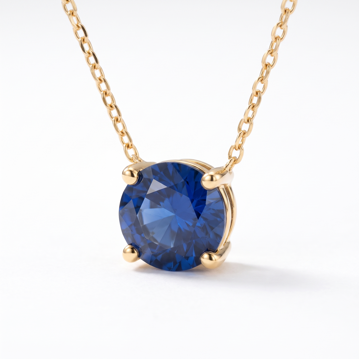 Round-cut blue sapphire solitaire necklace, angled front detail — AI-generated design representation