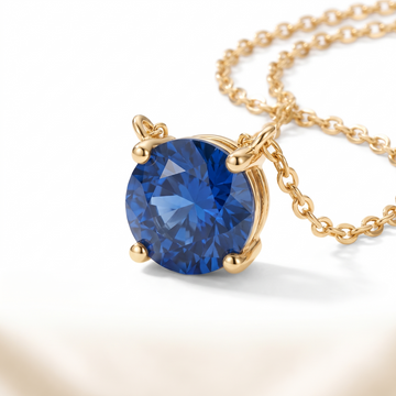Round-cut blue sapphire solitaire necklace, gemstone and setting detail — AI-generated design representation