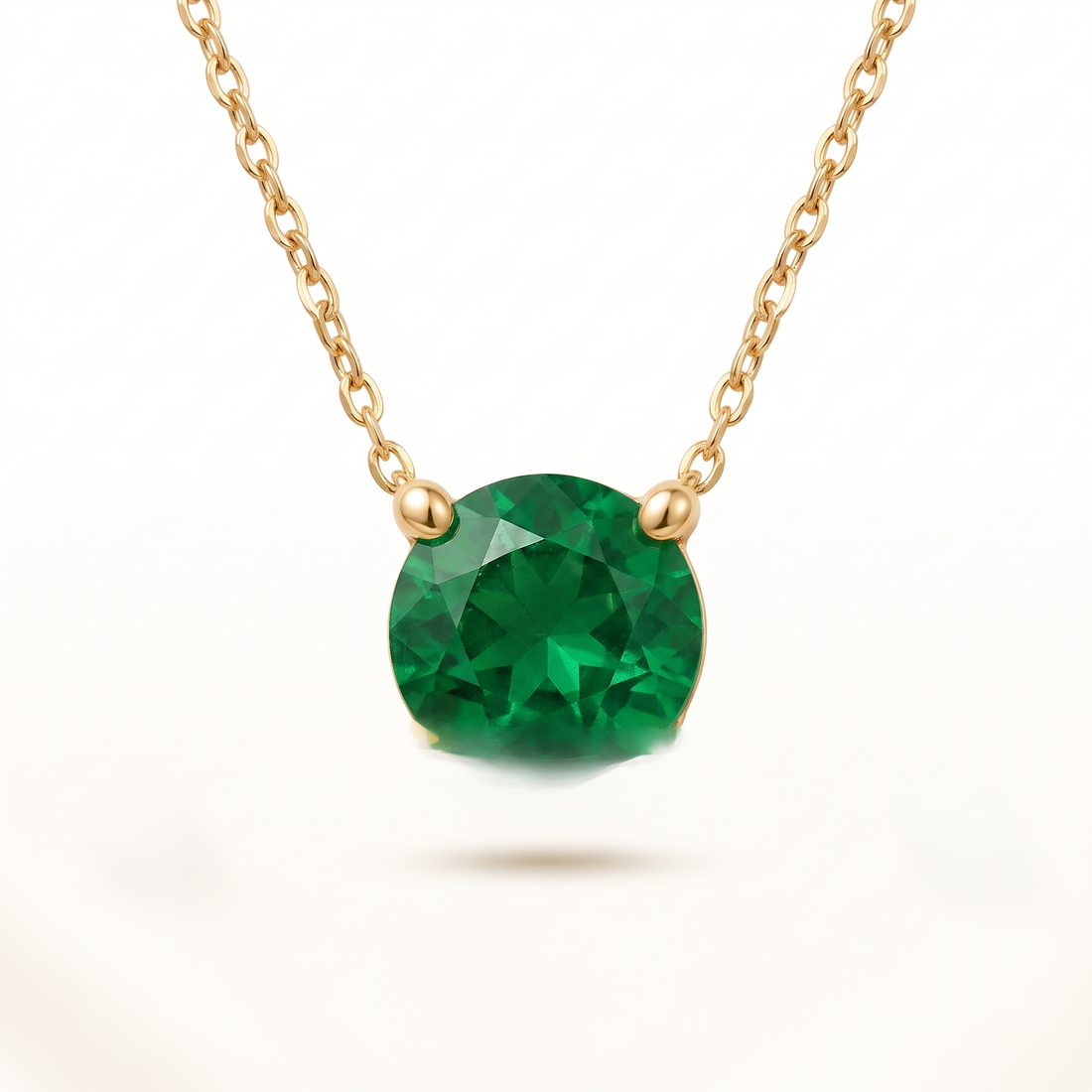 Round-cut emerald solitaire necklace in solid gold, catalog view — AI-generated design representation