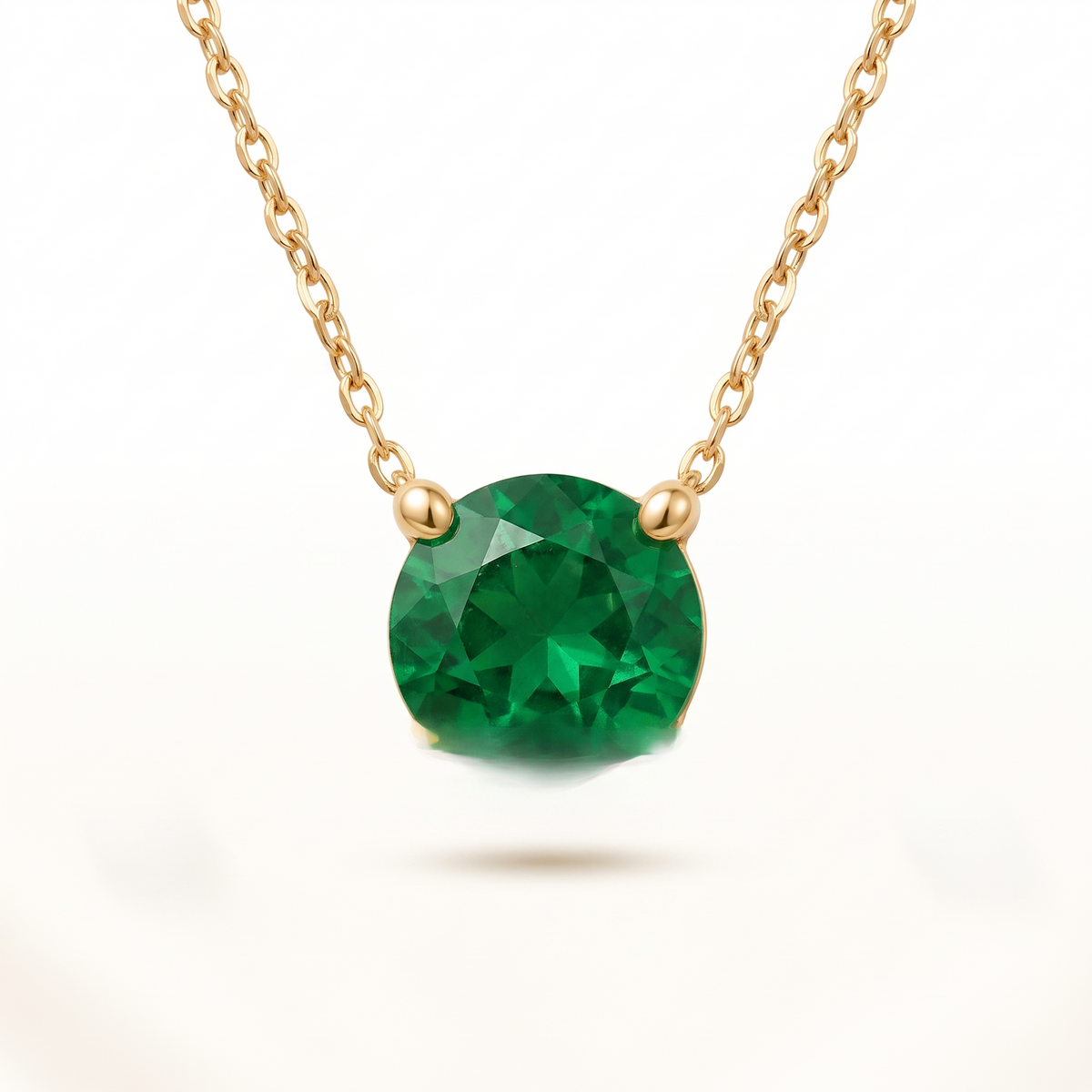 Round-cut emerald solitaire necklace in solid gold, catalog view — AI-generated design representation