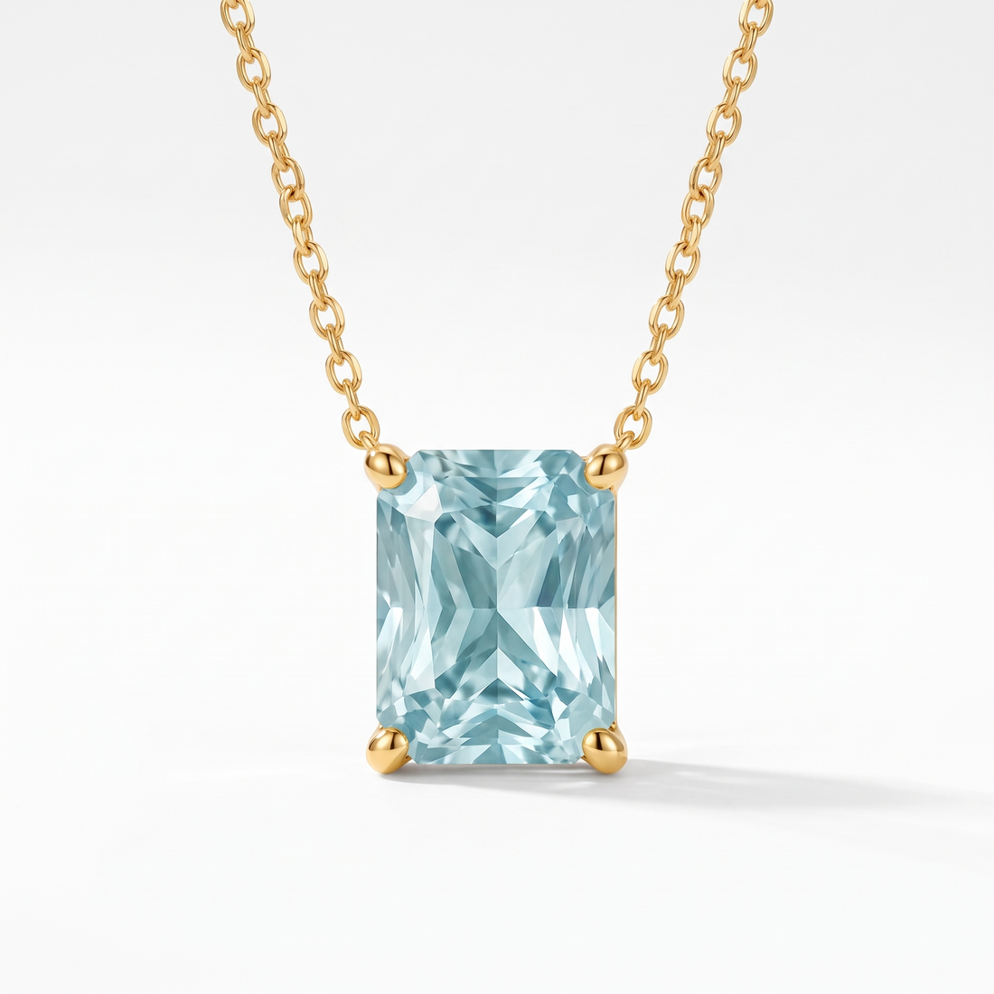 Radiant-cut aquamarine solitaire necklace in solid gold, catalog view — AI-generated design representation