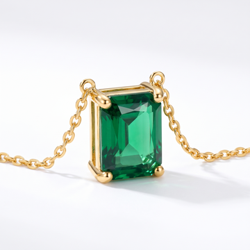 Radiant-cut emerald solitaire necklace, gemstone and setting detail — AI-generated design representation