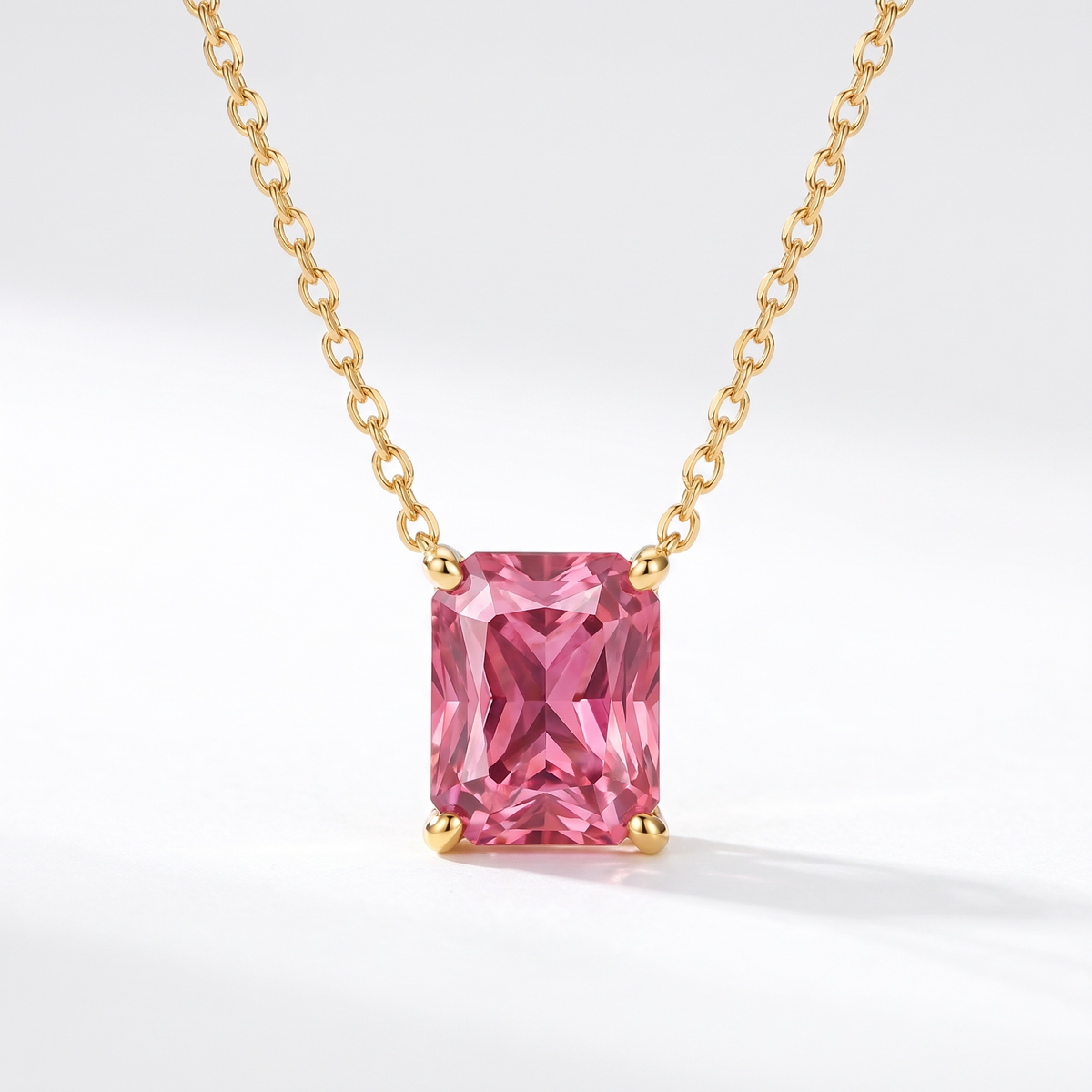 Radiant-cut pink tourmaline solitaire necklace in solid gold, catalog view — AI-generated design representation