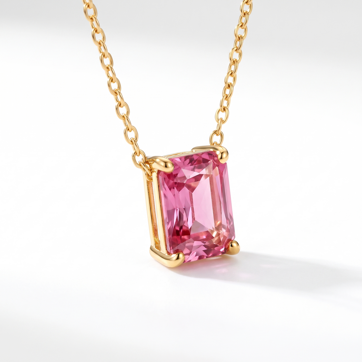 Radiant-cut pink tourmaline solitaire necklace, angled front detail — AI-generated design representation