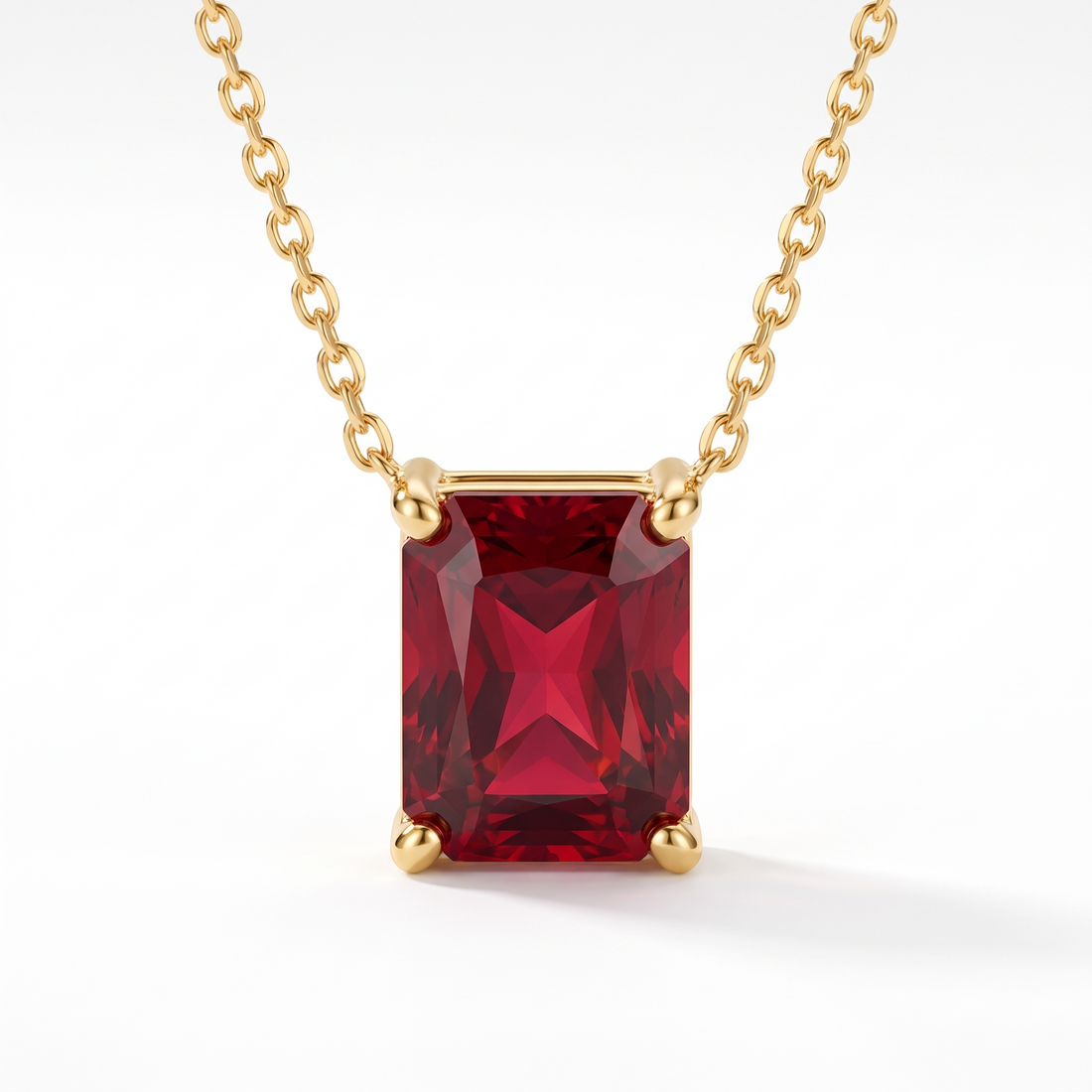 Radiant-cut ruby solitaire necklace in solid gold, catalog view — AI-generated design representation